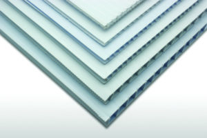 Stack of white corrugated plastic (polypropylene twinwall) sheets