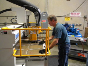 man completing projects faster, including polycarbonate sheets, with a premier plastics fabrication company