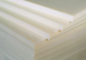 Stacks of white PVDF (Polyvinylidene Fluoride) plastic sheets