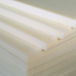 Stacks of white PVDF (Polyvinylidene Fluoride) plastic sheets