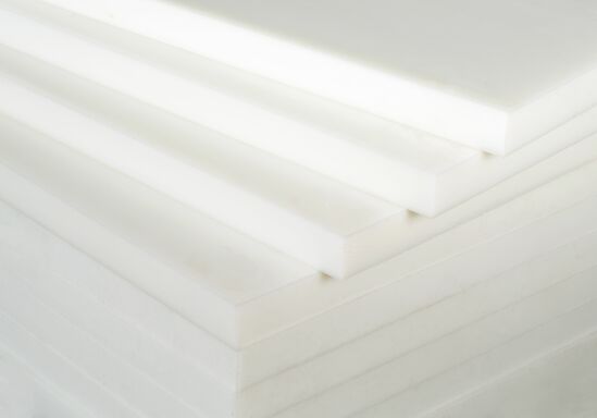 white UHMW plastic sheets stacked on top of each other