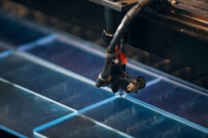 plastic sheet being cut by a laser cutter